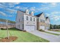 View of the townhome exteriors showcasing a side view of the homes, landscaping and driveways at 5761 Tillman Way, Powder Springs, GA 30127