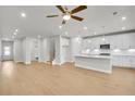 Spacious living area features hardwood floors and recessed lighting with open access to kitchen at 5761 Tillman Way, Powder Springs, GA 30127