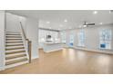 Bright, open floor plan features hardwood floors, recessed lighting and seamlessly connects to kitchen at 5761 Tillman Way, Powder Springs, GA 30127