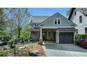 Stunning exterior view featuring gray siding, stylish windows, and a covered garage entrance at 7160 Round Rd, Cumming, GA 30040