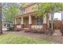 Inviting covered front porch with brick accents and pretty landscaping at 9912 Mancunian Way, Douglasville, GA 30135
