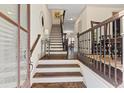 Inviting foyer featuring hardwood floors, a staircase with iron railings, and stylish décor, creating an elegant entrance at 1200 Virginia Ct # 101, Atlanta, GA 30306