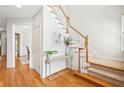 Bright foyer with hardwood floors, staircase, console table, and neutral decor at 1228 Dunwoody Walk, Atlanta, GA 30338