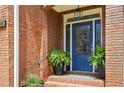 Elegant blue front door with glass detailing, potted plants, and brick accents at 1228 Dunwoody Walk, Atlanta, GA 30338
