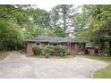 Charming brick home showcasing a concrete driveway, neatly trimmed hedges, and a freshly mowed lawn, perfect for curb appeal at 2383 N Decatur Rd, Decatur, GA 30033
