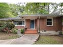 Quaint brick home featuring a tiled front entrance with a small step and manicured garden with flowering red rose bushes at 2383 N Decatur Rd, Decatur, GA 30033