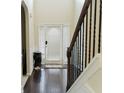 Bright entryway features hardwood floors, a high ceiling, and classic trim and a white front door at 3830 Kittery Pt, Snellville, GA 30039