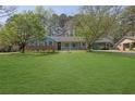 Quaint single-story brick home with well-kept lawn and a covered carport at 699 Rollingwood Dr, Stone Mountain, GA 30087