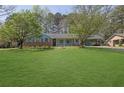 Quaint single-story brick home with well-kept lawn and a covered carport at 699 Rollingwood Dr, Stone Mountain, GA 30087