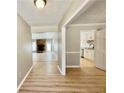 Bright hallway featuring wood floors, with views of the living room and kitchen area at 134 Carrollwood Dr, Fayetteville, GA 30215