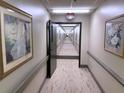 Hallway illuminated with recessed lights and decorative artwork on the walls at 300 Johnson Ferry Rd # B105, Atlanta, GA 30328