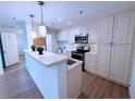 Well-lit kitchen featuring white cabinets, stainless steel appliances, and a convenient breakfast bar at 300 Johnson Ferry Rd # B105, Atlanta, GA 30328