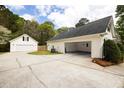 Spacious driveway leading to a detached two car garage, perfect for extra parking and storage at 794 Lucas Dr, Hampton, GA 30228