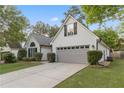 Traditional one-story home with attached two-car garage and a neatly kept lawn at 103 St Albans Way, Peachtree City, GA 30269