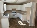 The kitchen features white cabinets, tile backsplash, and modern appliances at 3334 Rockmill Dr, Ellenwood, GA 30294