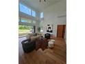 Bright living room featuring high ceilings, large windows, hardwood floors, and stylish furniture at 4450 Muhammad Dr, South Fulton, GA 30349