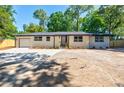 Single-story home with attached garage and large front parking pad at 3154 N Druid Hills Rd, Decatur, GA 30033