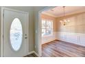 Inviting entryway with decorative front door and dining room featuring elegant chandelier at 4061 Preserve Trl, Snellville, GA 30039