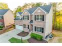 A charming two-story brick home featuring well-maintained landscaping and a two-car garage at 4061 Preserve Trl, Snellville, GA 30039
