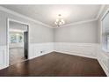Bright dining room with hardwood floors and elegant wainscoting at 1152 Bailing Dr, Lawrenceville, GA 30043