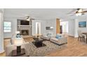 Bright living room boasts a cozy fireplace, neutral decor, and ample seating, perfect for relaxation and entertaining at 5306 Corinth Cir, Stone Mountain, GA 30087
