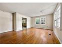 Spacious living room with hardwood floors and large windows providing natural light, creating a blank canvas for renovation at 631 N Hairston Rd, Stone Mountain, GA 30083