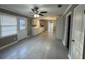 Open-concept living room boasts large windows, neutral paint, and modern tile floors at , Covington, GA 30014
