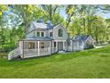 Beautiful two-story home with expansive lawn, covered porch and mature landscaping at 100 Little Ridge Rd, Berkeley Lake, GA 30096