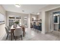 Bright dining area with backyard view, open to kitchen and next to a bathroom at 3476 Silver Maple Dr, Duluth, GA 30096