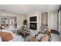 Inviting living room with a fireplace, modern furniture, and open access to the dining area at 3476 Silver Maple Dr, Duluth, GA 30096