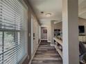 Inviting hallway with wood floors, leading to other areas of the home, with a window showcasing natural light at 522 Plantation Creek Dr, Loganville, GA 30052
