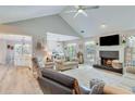Comfortable living room with vaulted ceiling, fireplace, and views of the dining area at 1337 Highfield Dr, Lawrenceville, GA 30043