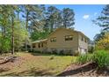 Traditional house with ample yard space, featuring a cozy front porch and driveway on a sunny day at 2062 Skyhawk Ln, Acworth, GA 30102