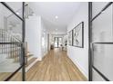 Bright foyer with hardwood floors, white walls, and views to the staircase and living room at 4785 Longchamps Dr, Sandy Springs, GA 30319