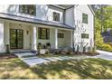Inviting front porch with black framed windows, brick facade, and stepping stone walkway at 4785 Longchamps Dr, Sandy Springs, GA 30319