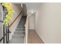 Inviting entryway with wood-look floors, a stairway to the upper level, and neutral paint at 4912 Waters Edge Trl, Roswell, GA 30075