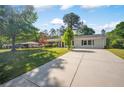 Inviting one-story home featuring a long driveway and lush green lawn leading to the front entrance at 4861 Alcan Rd, Powder Springs, GA 30127