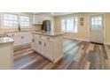 Well-lit kitchen with stainless steel appliances, a central island, and white cabinets at 5201 Skyline Dr, Stone Mountain, GA 30083