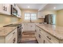 Modern kitchen featuring stainless steel appliances, granite countertops, and white cabinets at 5201 Skyline Dr, Stone Mountain, GA 30083