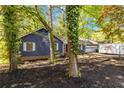 Lovely blue home showcases a well-maintained yard and a convenient attached garage at 5272 Cumberland Way, Stone Mountain, GA 30087