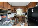 A messy kitchen with outdated appliances and cabinetry, requiring thorough cleaning and remodeling at 3090 Sunset Se Rd, Conyers, GA 30094
