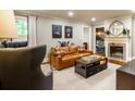 Cozy living room with fireplace, comfortable leather sofa, and stylish decor at 400 Collier Rd, Atlanta, GA 30309