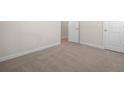 Spacious carpeted bedroom showcasing neutral walls, white trim, and paneled doors for easy personalization at 5443 Blossomwood Sw Trl, Mableton, GA 30126