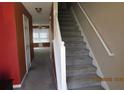 Entryway with carpeted stairs and view into the living room at 7238 April Ct, Morrow, GA 30260