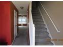 Entryway with carpeted stairs and view into the living room at 7238 April Ct, Morrow, GA 30260