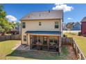 Backyard view featuring a screened porch, and privacy fence on a grassy lawn at 100 Cottage Nw Walk, Cartersville, GA 30121