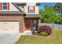 Inviting home entrance with a red front door, stone accents, and a well-manicured lawn at 100 Cottage Nw Walk, Cartersville, GA 30121