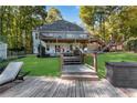 Expansive backyard with a spacious deck and steps down to a well-manicured lawn, perfect for outdoor activities at 10005 Lakeview Pkwy, Villa Rica, GA 30180
