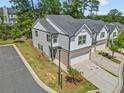 Aerial view of townhomes featuring attached garages and well-manicured lawns in a beautiful community at 1385 Vayda Ct, Marietta, GA 30066