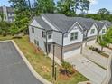 A lovely townhome with a two-car garage and a well-maintained lawn in a neighborhood setting at 1385 Vayda Ct, Marietta, GA 30066